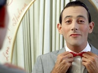 Actor Paul Reubens poses for a portrait dressed as his character Pee-wee Herman in May 1980.