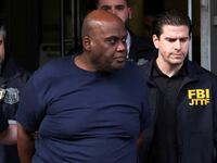 Frank James, the suspect in the Brooklyn subway shooting walks outside a police precinct
