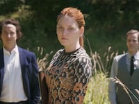Three people stand in a field in a still from 'Veni Vidi Vici'