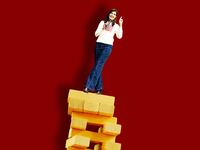 A photo illustration of Nikki Haley balancing on Jenga blocks.