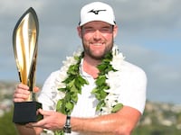 Grayson Murray of the United States poses with the trophy after winning the Sony Open in Hawaii in January.