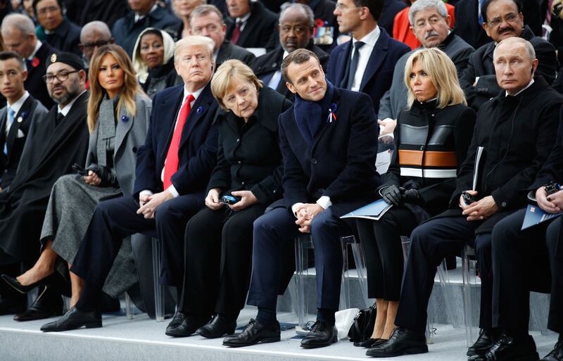 Morocco's King Mohammed VI (2nd L) and his son Crown Prince Hassan Moulay (L), US First Lady Melania Trump (3rd L), US President Donald Trump (C), German Chancellor Angela Merkel (4th R), French President Emmanuel Macron (3rd R), French President's wife Brigitte Macron (2nd R) and Russian President Vladimir Putin (R)