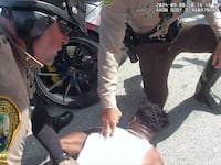 Tyreek Hill being arrested by Miami-Dade police officers.
