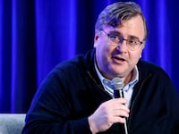 Reid Hoffman speaks on a stage.