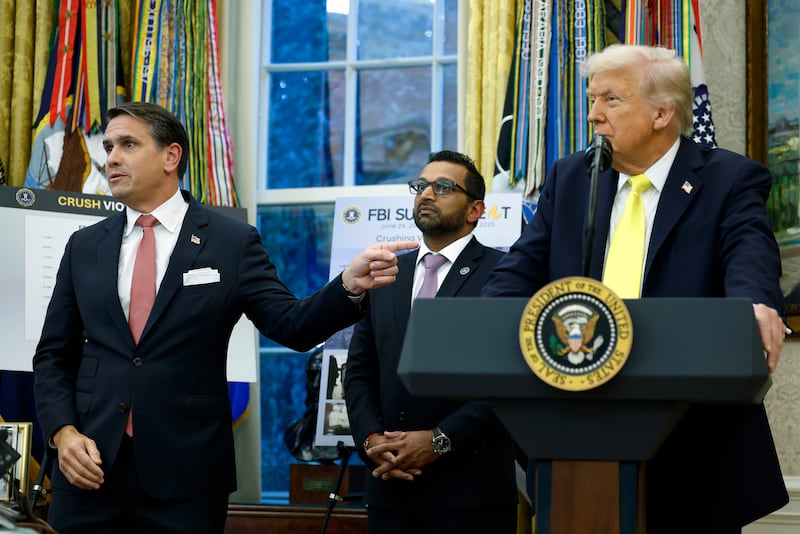 U.S. Deputy Attorney General Todd Blanche (L) gestures to U.S. President Donald Trump as he speaks