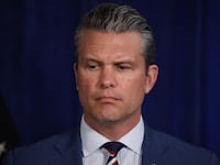 PALM BEACH, FLORIDA - JANUARY 03: U.S. Secretary of War Pete Hegseth listens as U.S. President Donald Trump addresses the media during a news conference at his Mar-a-Lago club on January 03, 2026, in Palm Beach, Florida. President Trump confirmed that the U.S. military carried out a large-scale strike in Caracas overnight, resulting in the capture of Venezuelan leader Nicolas Maduro and his wife, Cilia Flores. (Photo by Joe Raedle/Getty Images)