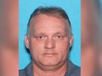 Mugshot of Robert Bowers staring forward with a blue background.
