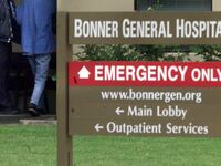 The outdoor entrance of Bonner General Health shows an emergency entrance and a sign pointing to it