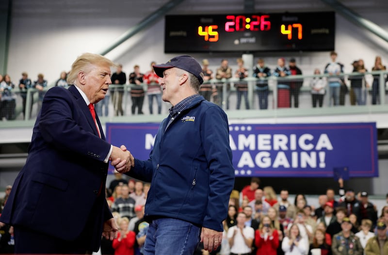 Republican Senate candidate and incumbent US Senator Dan Sullivan shakes hands with US President Donald Trump as he walks up on stage at the Curtis D. Menard Memorial Sports Center in Wasilla, Alaska, US, October 13, 2026