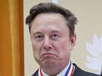 WASHINGTON, DC - OCTOBER 08: Tesla and SpaceX CEO Elon Musk (C) reacts after being awarded the National Medal of Science during the Golden Age of American Innovation Summit at the Institute of Peace on October 08, 2026 in Washington, DC. Trump awarded some of the nation's highest scientific honors to technology leaders including Elon Musk, Sergey Brin, Jensen Huang, Lisa Su, Michael Dell, and Satya Nadella. (Photo by Win McNamee/Getty Images)