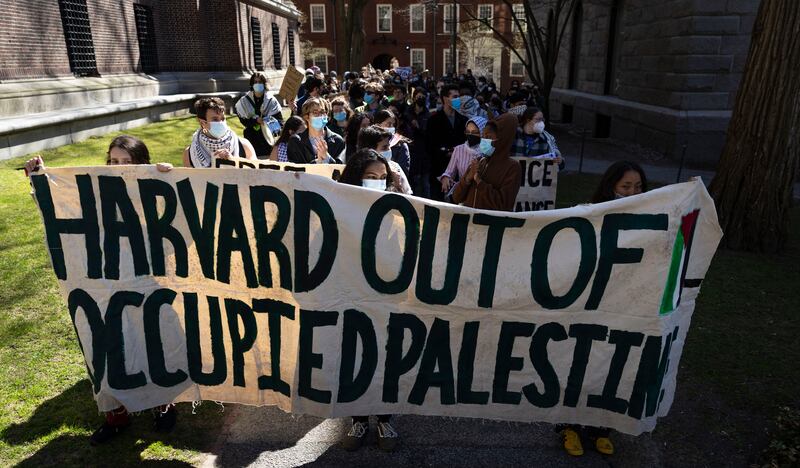 Protesters gather inside Harvard University to show their disapproval of actions taken under the Trump administration.