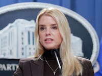 Pam Bondi stands behind a podium at the White House.