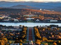 A scenic photograph of Canberra, Australia with mountains in the distance.