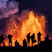 People watch as Hawaii's Kilauea Volcano erupts in Kailua-Kona on May 11, 2025, for the 21st time.