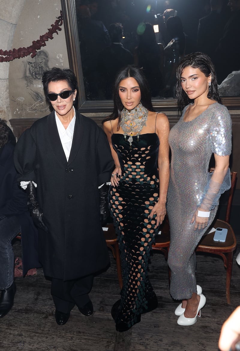 Kris Jenner, Kim Kardashian, and Kylie Jenner pose together at the Maison Margiela Fashion show on January 25, 2024, in Paris, France.
