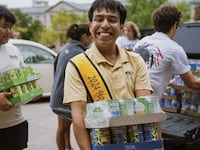 Johnathan Martinez pictured with canned goods donated to a food drive.