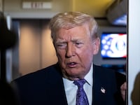 President Donald Trump speaks to the press aboard Air Force One