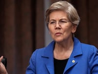 Sen. Elizabeth Warren (D-MA) speaks to a staff member before the start of a Senate Banking Committee hearing on oversight of credit reporting agencies, on Capitol Hill April 27, 2023 in Washington, DC.