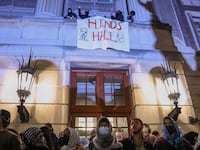 Protesters link arms outside Hamilton Hall barricading students inside the building at Columbia University in New York.