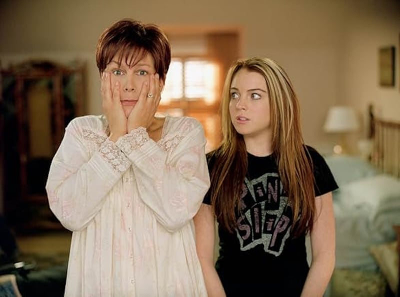 Lindsay Lohan appears next to her co-star Jamie Lee Curtis, wearing thick blond highlights in the 2003 film “Freaky Friday.”