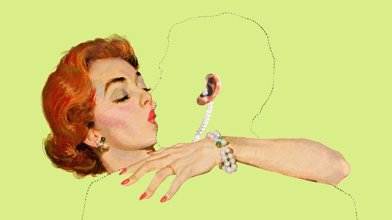 A woman kissing an outlined man with his ear and ear piece showing