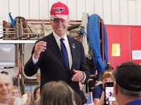Joe Biden dons a pro-Donald Trump hat during an appearance at a Pennsylvania fire station.