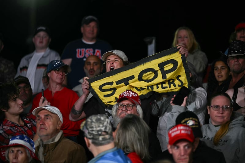 A protestor yells at US President Donald Trump as he speaks at a midterm campaign rally at Pitt-Greenville Airport in Greenville, North Carolina, on October 20, 2026. (Photo by Kent NISHIMURA / AFP via Getty Images)