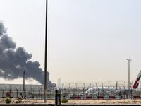 A smoke plume rises from an ongoing fire near Dubai International Airport in Dubai on March 16, 2026.
