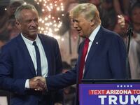 Robert F. Kennedy Jr. shakes hands with Donald Trump on stage.