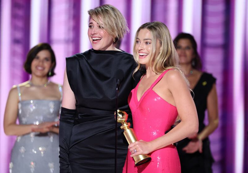 "Greta Gerwig and Margot Robbie accept the award for Cinematic and Box Office Achievement for \"Barbie\" at the 81st Golden Globe Awards held at the Beverly Hilton Hotel on January 7, 2024 in Beverly Hills, California