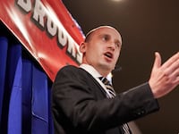 Former Trump adviser Stephen Miller speaks before U.S. Rep. Mo Brooks (R-AL) at a campaign rally