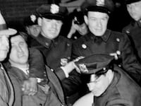 Police arrest Isidore Greenbaum during a Nazi meeting at Madison Square Garden.