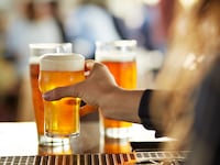 A bartender serves beers at a bar.