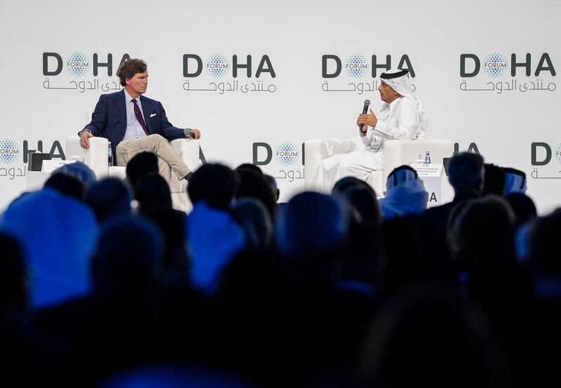 Qatari Prime Minister and Foreign Minister Mohammed bin Abdulrahman Al Thani (R) answers questions from journalist Tucker Carlson (L) during the 'Newsmaker Interview' session held as part of the Doha Forum 2025 in Doha, Qatar on December 07, 2025.