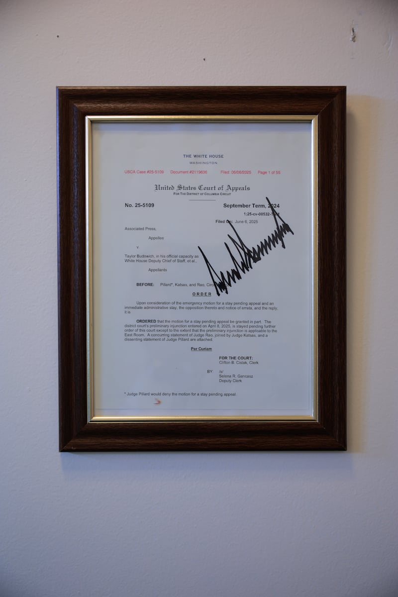 WASHINGTON, DC - JULY 24: A copy of a the U.S. Court of Appeals for the D.C. Circuit order against the Associated Press is signed by President Donald Trump, framed and displayed on the wall in the Brady Press Briefing Room at the White House on July 24, 2025 in Washington, DC. The order says that Trump may continue to bar the Associated Press from some White House media events while the news agency's lawsuit against the administration moves forward. (Photo by Chip Somodevilla/Getty Images)