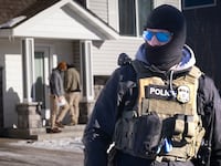 CEDAR PINES, MINNESOTA - JANUARY 28: ICE agents look for someone at a home on January 28, 2026 in Circle Pines, Minnesota. Protests continue around the Twin Cities area after the Trump administration sent thousands of immigration agents to the region to search for undocumented immigrants, leading to the deaths of Renee Good on January 7, and Alex Pretti on January 24 in fatal shootings by federal agents. (Photo by Scott Olson/Getty Images)