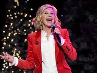 Olivia Newton-John singing into a microphone.