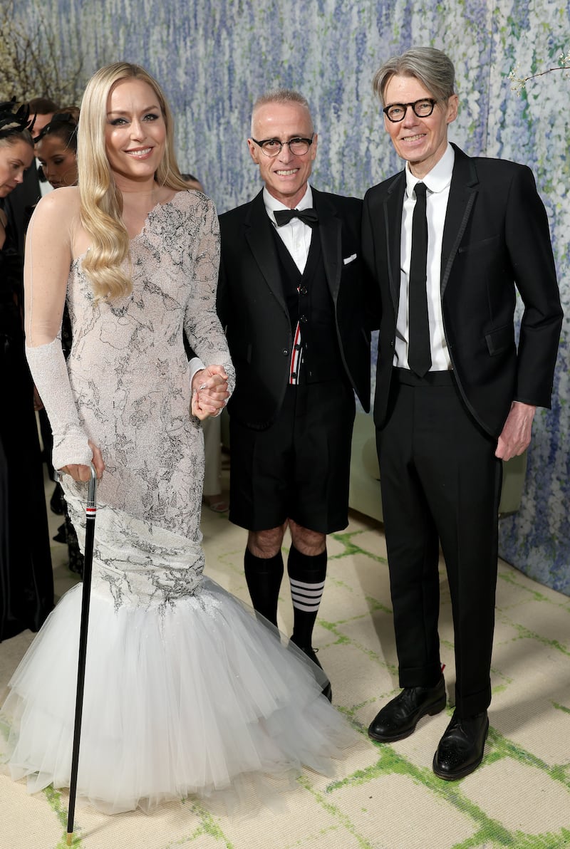 Lindsey Vonn used a custom cane to help her walk at the 2026 Met Gala. Pictured here with designer Thom Browne and the Costume Center's curator Andrew Bolton at the Metropolitan Museum of Art in New York City.