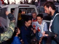 Hostages who were abducted by Hamas exit trucks and are released to the Red Cross