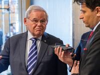 Bob Menendez speaks to a reporter at the U.S. Capitol.