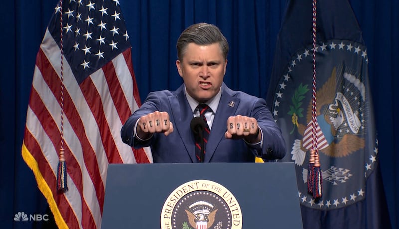 SNL, Colin Jost as Pete Hegseth showing off his 'Epic Fury' tattoos. (NBC)