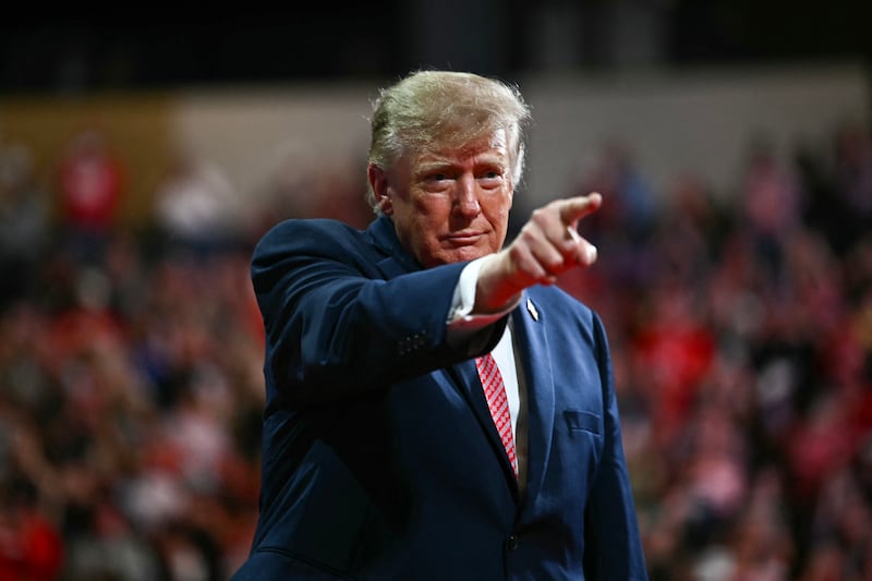 President Donald Trump points to the crowd during a campaign rally at the Heartland Credit Union Arena in Park City, Kansas, a suburb of Wichita, on October 19, 2026.