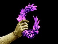 A photo illustration of the hand of a Greek statue clenching a pink laurel wreath