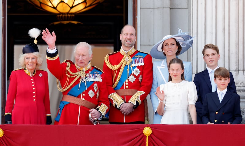 The royal family greets onlookers from the balcony of Buckingham Palace. From left: Queen Camilla, King Charles III, Prince William, Princess Catherine, Princess Charlotte, Prince George, and Prince Louis.