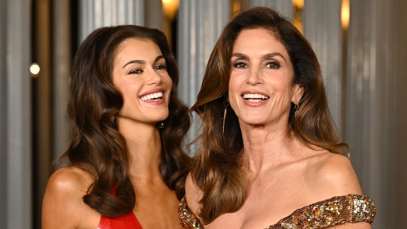 Kaia Gerber and Cindy Crawford pose, smiling and giggling, at the 2025 LACMA Art + Film Gala.