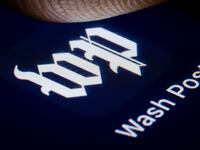 In this photo illustration the logo of major American daily newspaper The Washington Post is displayed on a smartphone