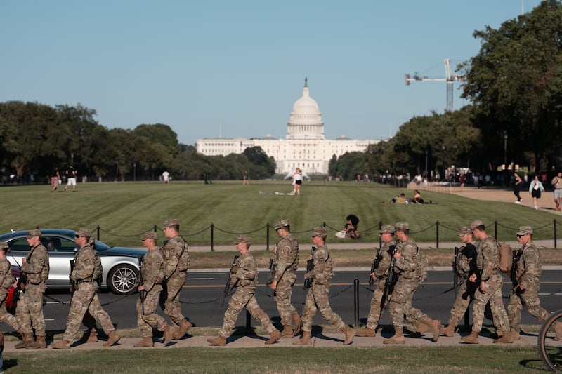 WASHINGTON, DC - AUGUST 30: A National Guard unit patrols the National Mall on August 30, 2025 in Washington, DC. The Metropolitan Police helped both teams leave via their buses after the game was suspended. The Trump administration has deployed federal officers and the National Guard to the District in order to place the DC Metropolitan Police Department under federal control and assist in crime prevention in the nation's capital. (Photo by Andrew Leyden/Getty Images)
