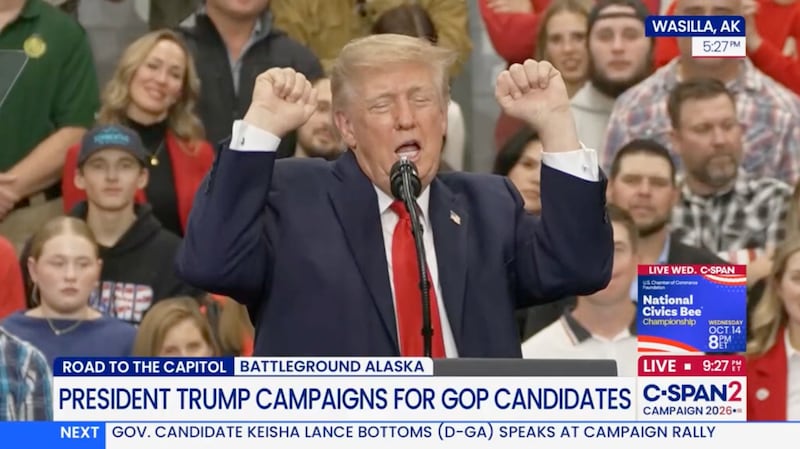 Donald Trump impersonates a weightlifter during a rally in Alaska.