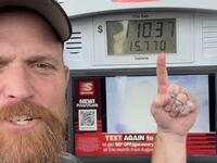 Country rapper Adam Calhoun stands in front of a diesel pump and discusses the high cost of living.