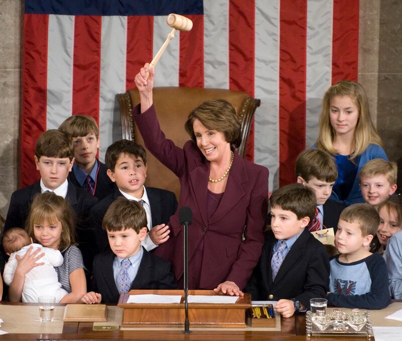 House Speaker Nancy Pelosi takes the gavel on Jan. 4 2007 surrounded by children including her own grandchildren, after being elected the first woman to serve as speaker.